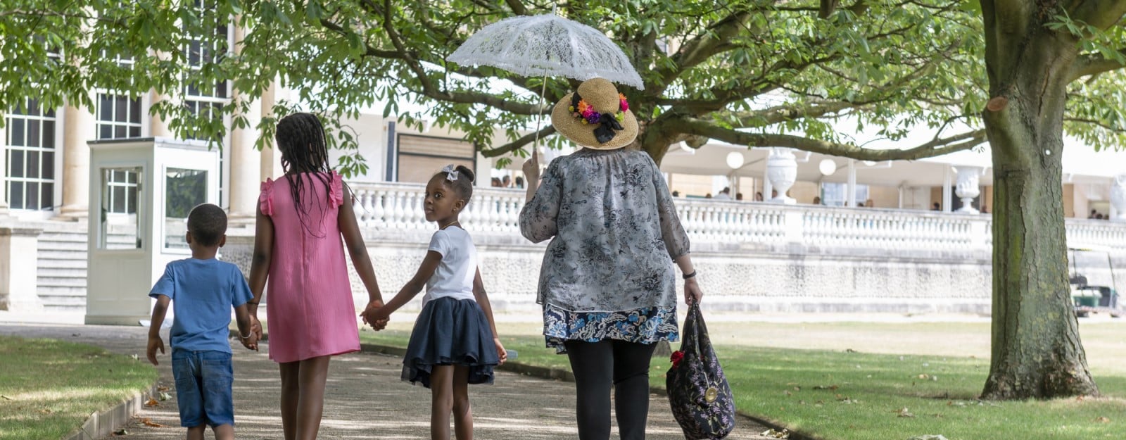 A family walking through the Buckingham Palace Garden